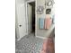 Bathroom with patterned tile floor, closet, and decorative wall art at 19864 W San Juan Ave, Litchfield Park, AZ 85340