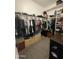 Walk-in closet features several shelves, hanging clothes and dresser drawers at 19864 W San Juan Ave, Litchfield Park, AZ 85340