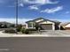 Charming home featuring desert landscaping, lush green shrubbery, and mountain views at 19864 W San Juan Ave, Litchfield Park, AZ 85340