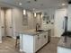 Kitchen island with a stainless dishwasher, black faucet and granite countertop at 19864 W San Juan Ave, Litchfield Park, AZ 85340