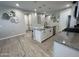 Kitchen island features granite countertop, black sink and faucet, white cabinets and stainless dishwasher at 19864 W San Juan Ave, Litchfield Park, AZ 85340