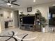 Spacious living room with ceiling fan, modern area rug, and entertainment center at 19864 W San Juan Ave, Litchfield Park, AZ 85340