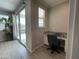 Office features wood-look tile floors, white cabinets, and sliding glass doors to patio at 19864 W San Juan Ave, Litchfield Park, AZ 85340