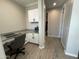 Office features wood-look tile floors, white cabinets and granite countertops at 19864 W San Juan Ave, Litchfield Park, AZ 85340