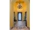 Welcoming entryway with brick floor, decorative front door and chandelier at 2005 N Pomelo --, Mesa, AZ 85215