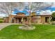 Beautiful home with stone accents, fountain, lush green lawn and a circular driveway at 2005 N Pomelo --, Mesa, AZ 85215