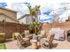 A cozy backyard retreat with comfortable lounge chairs, a grill, and tropical palm trees for relaxing at 2116 S Moccasin Trl, Gilbert, AZ 85295