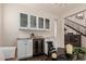 Chic bar area equipped with wine fridge and glass cabinets, perfect for entertaining guests at 2116 S Moccasin Trl, Gilbert, AZ 85295