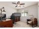 Bedroom featuring a ceiling fan, natural light, and neutral-toned decor at 2116 S Moccasin Trl, Gilbert, AZ 85295