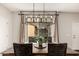 Dining area showcasing an elegant light fixture and view of backyard through glass sliding door at 2116 S Moccasin Trl, Gilbert, AZ 85295