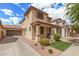 Charming two-story home featuring a covered porch, landscaped yard, and a two-car garage at 2116 S Moccasin Trl, Gilbert, AZ 85295