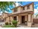 Beautiful two-story home with a covered porch, well-manicured lawn, and inviting curb appeal at 2116 S Moccasin Trl, Gilbert, AZ 85295