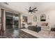 Spacious living room with modern ceiling fan, sliding glass doors, and contemporary furnishings at 2116 S Moccasin Trl, Gilbert, AZ 85295