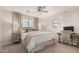 This spacious main bedroom features natural light, a ceiling fan, and calming neutral tones at 2116 S Moccasin Trl, Gilbert, AZ 85295