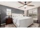 Well-lit main bedroom with a ceiling fan, neutral tones, and a large window for a peaceful ambiance at 2116 S Moccasin Trl, Gilbert, AZ 85295