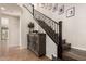 Elegant staircase with dark wood steps, iron railing, and decorative cabinet in the entry of this beautiful home at 2116 S Moccasin Trl, Gilbert, AZ 85295