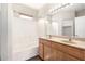 Bathroom with double sinks, wood cabinets and a shower-tub combo at 22125 N 29Th Ave # 158, Phoenix, AZ 85027