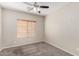 Neutral bedroom with carpet flooring, a ceiling fan, and window with blinds at 22125 N 29Th Ave # 158, Phoenix, AZ 85027