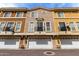 Exterior shot of multi-level townhomes with garage doors and small balconies at 22125 N 29Th Ave # 158, Phoenix, AZ 85027