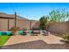 Cozy backyard seating area with artificial turf and stylish outdoor furniture at 22800 E Via Las Brisas Rd, Queen Creek, AZ 85142