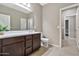 Clean bathroom featuring dark wood cabinets, tile flooring, a large mirror and neutral paint at 22800 E Via Las Brisas Rd, Queen Creek, AZ 85142