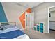 Colorful bedroom with geometric wall designs, a wood bed frame, and blue storage containers at 22800 E Via Las Brisas Rd, Queen Creek, AZ 85142