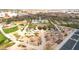 Aerial of a community garden with raised beds, walking paths, and shade structures, creating a vibrant outdoor space at 22800 E Via Las Brisas Rd, Queen Creek, AZ 85142