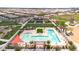 Aerial view of a community pool with lounge chairs, a shade structure, and landscaping for outdoor enjoyment at 22800 E Via Las Brisas Rd, Queen Creek, AZ 85142