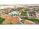 Community aerial view showcasing a beautiful swimming pool, playground, and clubhouse amidst well-maintained landscaping at 22800 E Via Las Brisas Rd, Queen Creek, AZ 85142