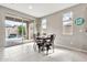 Dining area with modern table and chairs, bright lighting, and access to the backyard at 22800 E Via Las Brisas Rd, Queen Creek, AZ 85142