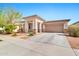 Well-maintained exterior showcasing a large driveway leading to a two-car garage at 22800 E Via Las Brisas Rd, Queen Creek, AZ 85142