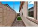 Exterior of a house with a patch of artificial grass between walls at 22800 E Via Las Brisas Rd, Queen Creek, AZ 85142