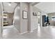 Hallway featuring neutral paint, tile flooring, and tasteful decorations, leading to multiple rooms in the home at 22800 E Via Las Brisas Rd, Queen Creek, AZ 85142