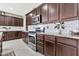 Modern kitchen design with ample counter space, stainless appliances, and dark wooden cabinetry at 22800 E Via Las Brisas Rd, Queen Creek, AZ 85142