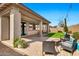 Covered patio area with pavers, outdoor furniture, and manicured landscaping at 22800 E Via Las Brisas Rd, Queen Creek, AZ 85142