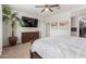 Relaxing bedroom offering a ceiling fan, entertainment setup, and a glimpse of a walk-in closet at 2426 E San Gabriel Trl, Casa Grande, AZ 85194