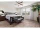 Spacious bedroom featuring a ceiling fan, large windows, and a cozy sitting area at 2426 E San Gabriel Trl, Casa Grande, AZ 85194