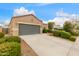 Single-Gathering house with a spacious driveway, gray garage door, and well-maintained landscaping at 2426 E San Gabriel Trl, Casa Grande, AZ 85194