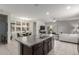 Bright, open kitchen with a large island, stainless steel sink, and view of the dining and living area at 2426 E San Gabriel Trl, Casa Grande, AZ 85194