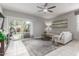 Comfortable living room featuring tile flooring, a neutral-toned sofa, and a sliding glass door to the backyard at 2426 E San Gabriel Trl, Casa Grande, AZ 85194