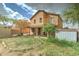 A two-story home showcases an upper-level balcony and covered patio with a grass backyard at 2501 N 114Th Ave, Avondale, AZ 85392