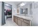 A spacious bathroom featuring double sinks, granite counters, and a large walk-in closet at 2501 N 114Th Ave, Avondale, AZ 85392