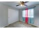 Bedroom featuring tile flooring, a ceiling fan, and a window for natural light at 2501 N 114Th Ave, Avondale, AZ 85392