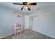 This bright bedroom features decorated walls, tile flooring, and access to the hallway at 2501 N 114Th Ave, Avondale, AZ 85392