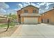 Charming two-story home features a front yard with a palm tree and a two-car garage at 2501 N 114Th Ave, Avondale, AZ 85392