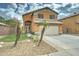 Charming two-story home features a front yard with palm trees and a two-car garage at 2501 N 114Th Ave, Avondale, AZ 85392