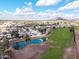 Community aerial view featuring white tile roofs, a golf course, a pond, and mountains in the distance at 2537 N Miller Rd, Scottsdale, AZ 85257