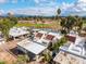 Community aerial view featuring golf course, pond, and white roofs, some with solar panels at 2537 N Miller Rd, Scottsdale, AZ 85257