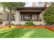 Inviting covered back patio with lush landscaping and comfortable outdoor seating overlooking a well-manicured artificial lawn at 2537 N Miller Rd, Scottsdale, AZ 85257