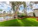 Beautiful backyard featuring an artificial lawn, manicured plantings, and a wrought iron fence around the yard at 2537 N Miller Rd, Scottsdale, AZ 85257